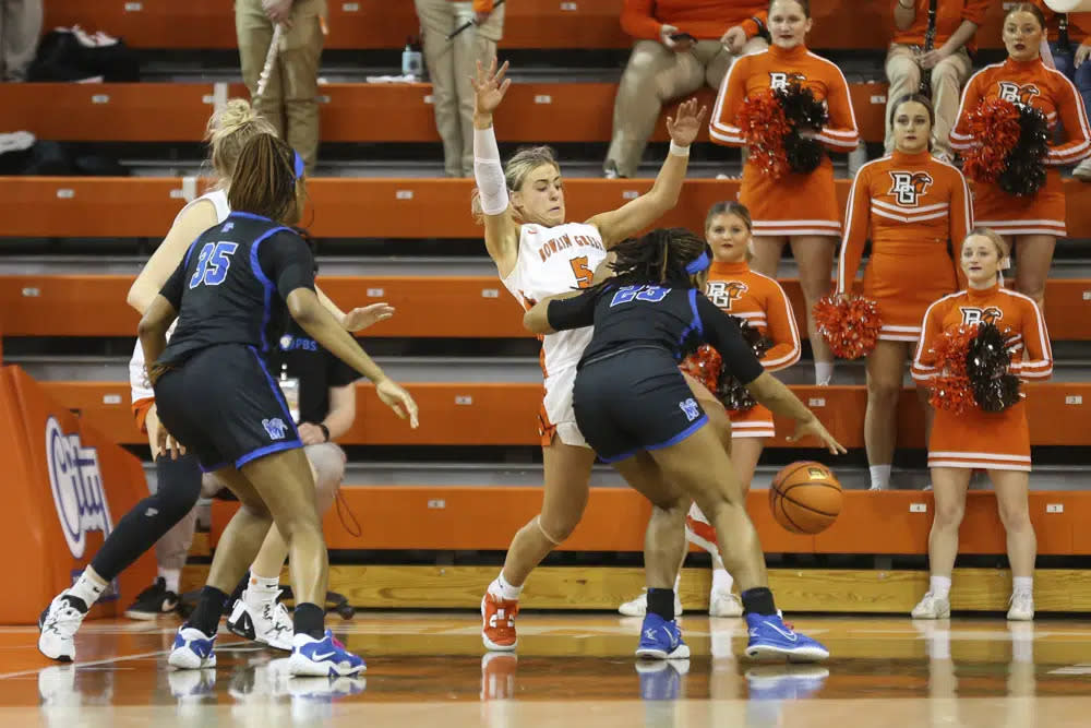 Bowling Green guard Elissa Brett (5) draws a charging foul against Memphis guard Jamirah Shutes (23) during the second half of a WNIT game at the Stroh Center in Bowling Green, Ohio, Friday March 23, 2023. (Scott Grau/Sentinel-Tribune via AP)