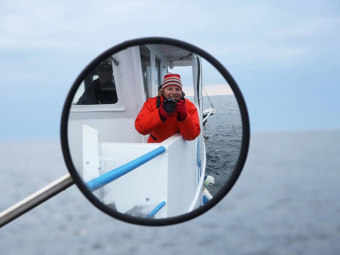 Julie D'Amour-Léger takes a selfie on a crab boat. Her love for photography started at the age of 12 when she got her first 35-mm camera. (Julie D'Amour-Léger - image credit)