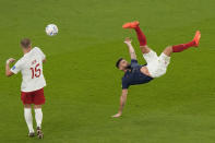 France's Olivier Giroud goes for an overhead kick during the World Cup round of 16 soccer match between France and Poland, at the Al Thumama Stadium in Doha, Qatar, Sunday, Dec. 4, 2022. (AP Photo/Luca Bruno)