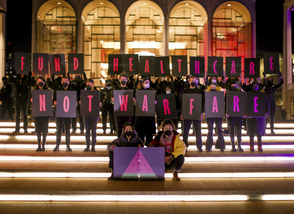 In this photo provided by Jewish Voice for Peace, protesters demonstrate outside Lincoln Center on World AIDS Day, Dec. 1, 2023, in New York. Watermelons have emblazoned banners, T-shirts, balloons and social media over the past three months in global protests against the Israel-Hamas war. From New York and Tel Aviv to Dubai and Belgrade, the fruit has caught on globally as a symbol of solidarity with the Palestinian people. (Alexa Wilkinson/Jewish Voice for Peace via AP)