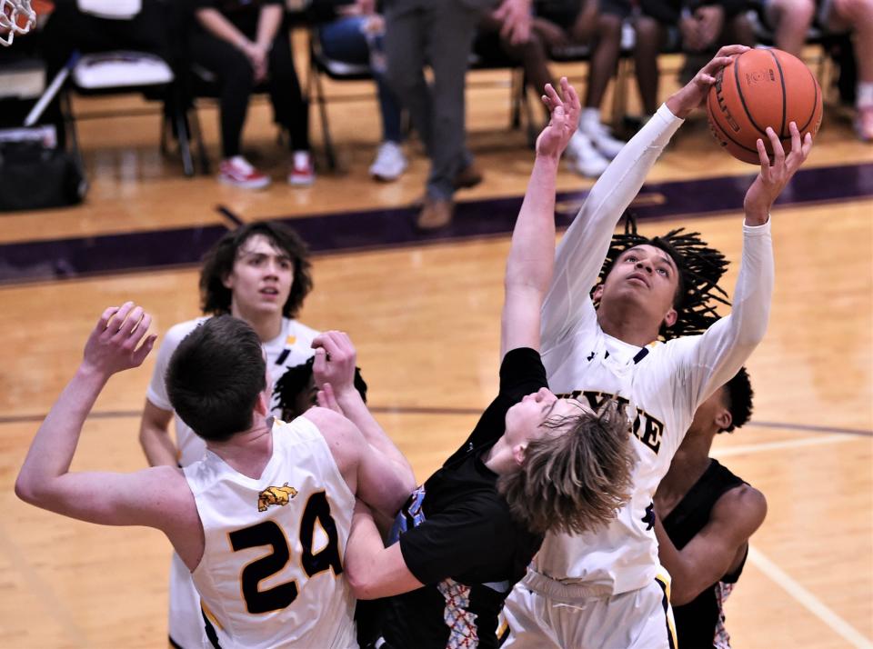 Wylie's Derek Evans grabs a rebound over Lubbock Monterey's Carter Bovkoon in the second half.