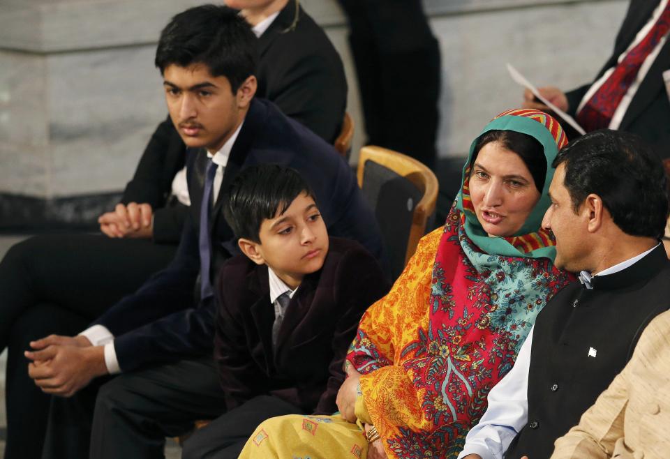 Family members of Nobel Peace Prize laureate Malala Yousafzai (not seen) attend the Nobel Peace Prize awards ceremony at the City Hall in Oslo December 10, 2014. Pakistani teenager Yousafzai, who was shot in the head by the Taliban in 2012 for advocating girls' right to education, has won the prize along with Indian campaigner against child trafficking and labor, Kailash Satyarthi. REUTERS/Suzanne Plunkett (NORWAY - Tags: SOCIETY)