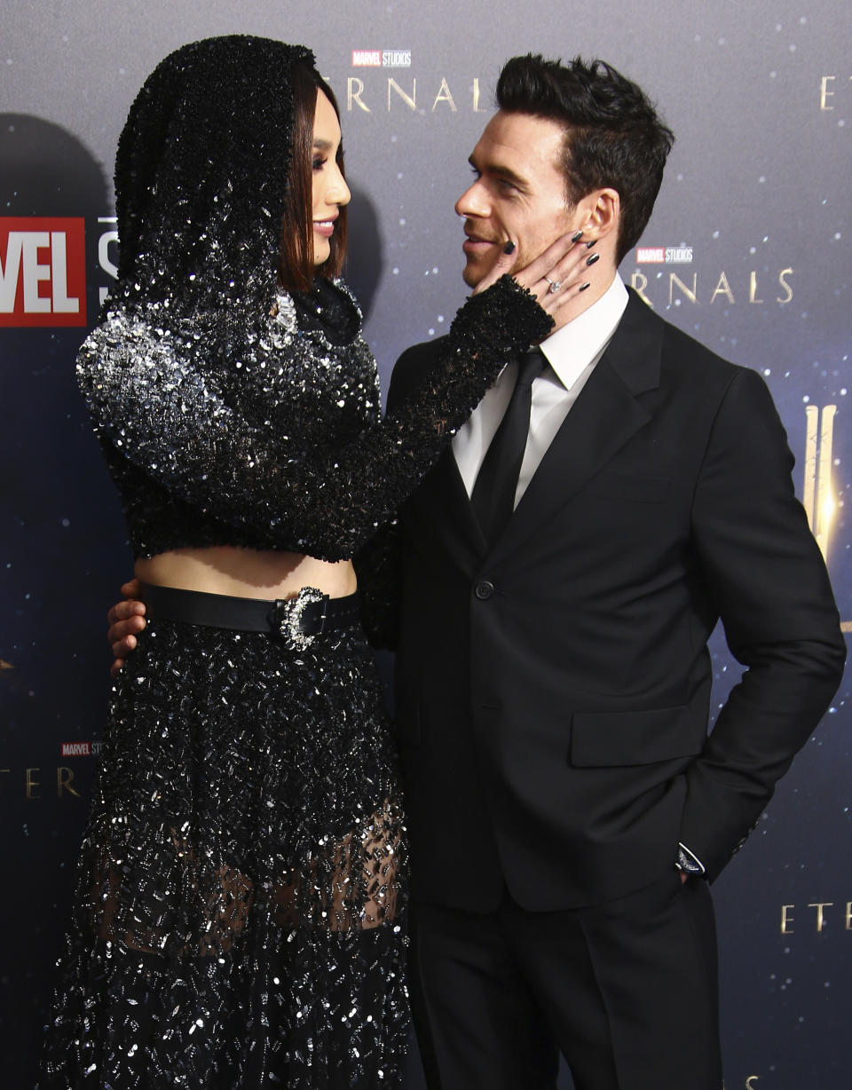 Gemma Chan, left, and Richard Madden pose for photographers upon arrival at the premiere of the film 'Eternals' on Wednesday, Oct. 27, 2021, in London. (Photo by Joel C Ryan/Invision/AP)