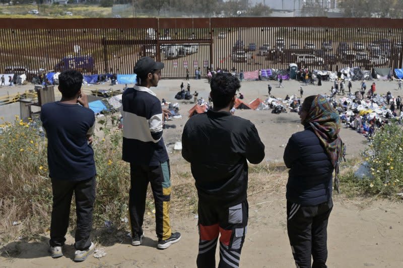 Migrants are stuck between the primary and secondary fencing at the Tijuana-San Diego border for over a week in May as Title 42 neared its expiration. File Photo by Carlos Moreno/UPI