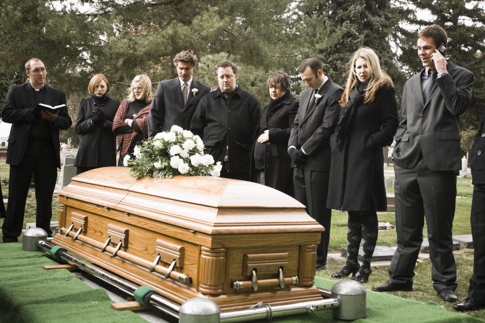 people at a funeral in a cemetery