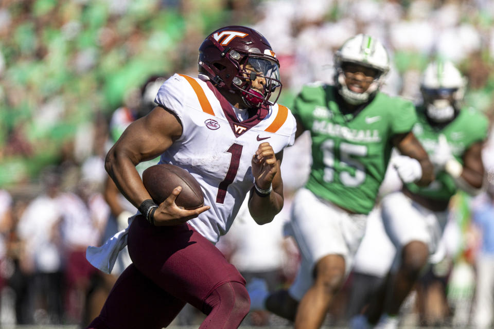 Virginia Tech quarterback Kyron Drones runs up field for a score against Marshall during an NCAA college football game, Saturday, Sept. 23, 2023, at Joan C. Edwards Stadium in Huntington, W.Va. (Sholten Singer/The Herald-Dispatch via AP)