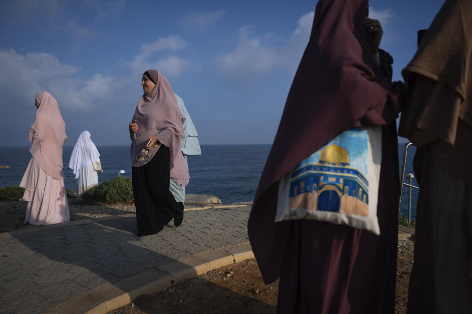 Muslim worshippers gather for Eid al-Adha prayer in Jaffa, a mixed Arab-Jewish area of Tel Aviv, Israel, Wednesday, June 28, 2023. Muslims celebrate the holiday to mark the willingness of the Prophet Ibrahim (Abraham to Christians and Jews) to sacrifice his son. During the holiday, they slaughter sheep or cattle, distribute part of the meat to the poor and eat the rest. (AP Photo/Oded Balilty)