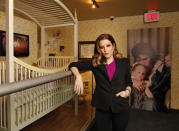 FILE - Lisa Marie Presley stands next to her childhood crib displayed with other mementos in the new exhibit "Elvis Through His Daughter's Eyes," at Graceland in Memphis, Tenn., Jan. 31, 2012. She was born on Feb. 1, 1968. Lisa Marie Presley, singer and only child of Elvis, died Thursday, Jan. 12, 2023, after a hospitalization, according to her mother, Priscilla Presley. She was 54. (AP Photo/Lance Murphey, File)