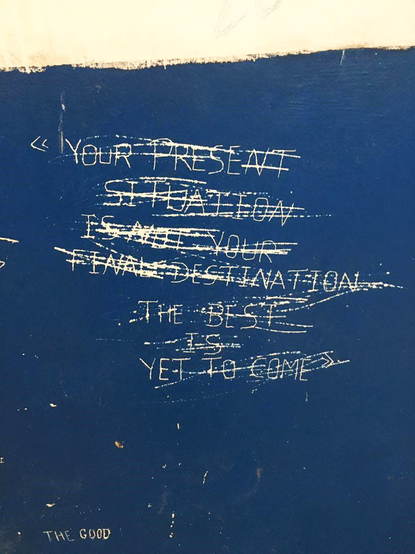 A message is scratched out on a wall inside the Gharyan Detention Center in Libya. (The Outlaw Ocean Project)