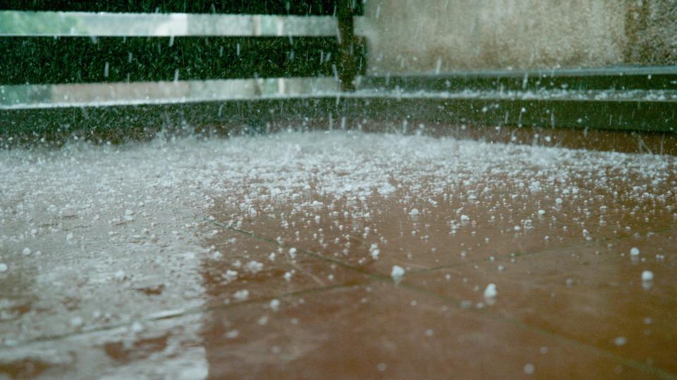 Close up of sleet falling on sidewalk. 