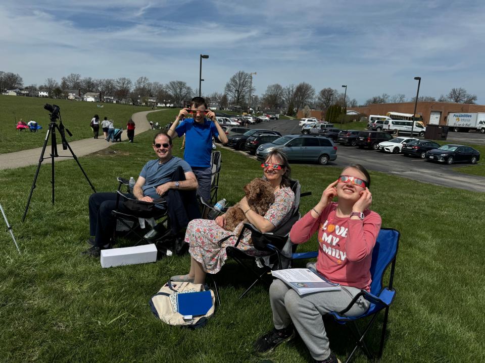 Thomas, 11, John, Amy and Gianna, 13, O’Callaghan of Gaithersburg, Maryland, found a comfortable place on Ashland’s Freer Field for solar eclipse viewing.