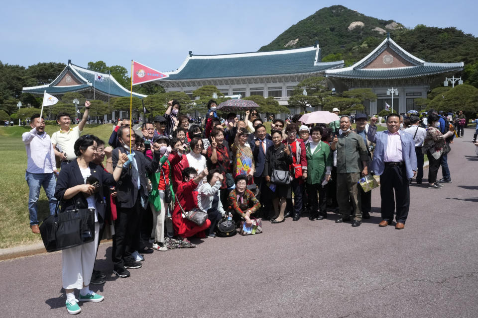 A group of visitor pose together at the Blue House, the former presidential palace, in Seoul, South Korea, Thursday, May 12, 2022. For most South Koreans, the former presidential palace in Seoul was as shrouded in mystery as the buildings in their secretive rival North Korea. That’s now changed recently as thousands have been allowed a look inside for the first time in 74 years.(AP Photo/Ahn Young-joon)