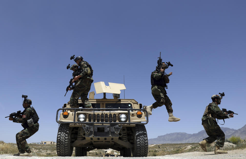 FILE - Afghan soldiers patrol outside their military base on the outskirts of Kabul, Afghanistan, May 9, 2021. At a time when Americans are deeply divided along party lines, a new poll shows agreement on at least one issue: the United.States' two-decade long war in Afghanistan was not worth fighting.(AP Photo/Rahmat Gul, File)