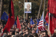 People holding EU, US and Albanian flags take part in an an anti-government protest held near a summit of European Union leaders and their counterparts from the Western Balkans in the capital Tirana, Albania, on Tuesday, Dec. 6, 2022. Sali Berisha, a 78-year-old former president, prime minister and the leader of the Albanian opposition center-right Democratic Party has been attacked during protest when a man came out of the crowd and punched him in the face. The opposition was protesting against alleged corruption by Prime Minister Edi Rama, which they blame for the country's cost-of-living crisis.(AP Photo/Franc Zhurda)