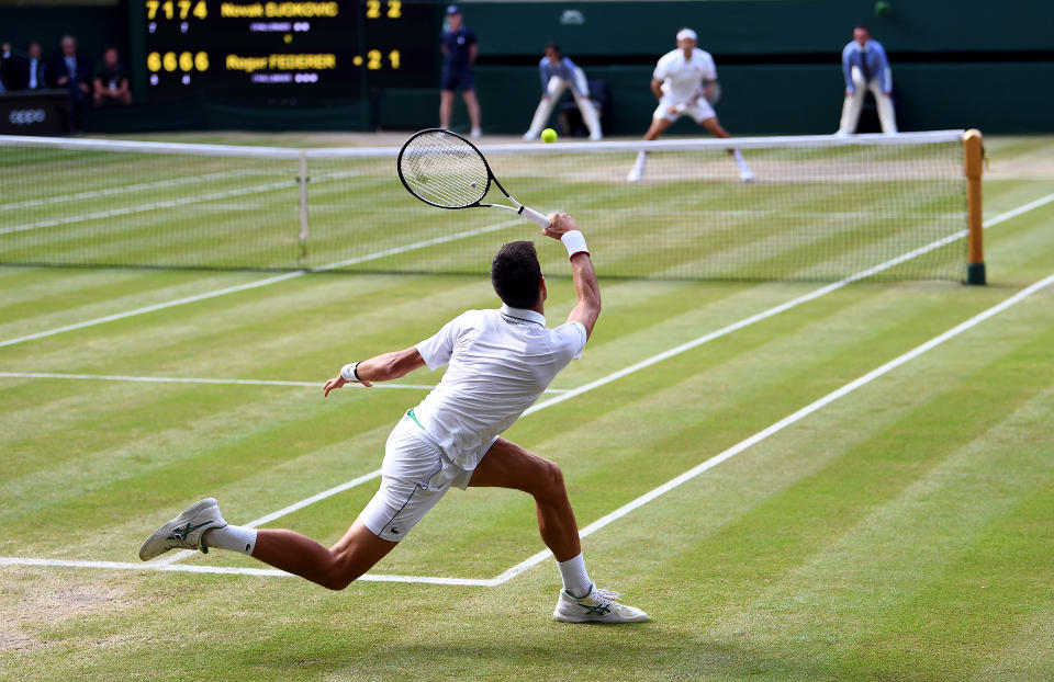 Roger Federer (top) and Novak Djokovic in action in the mens singles final on day thirteen of the Wimbledon Championships at the All England Lawn Tennis and Croquet Club, Wimbledon.