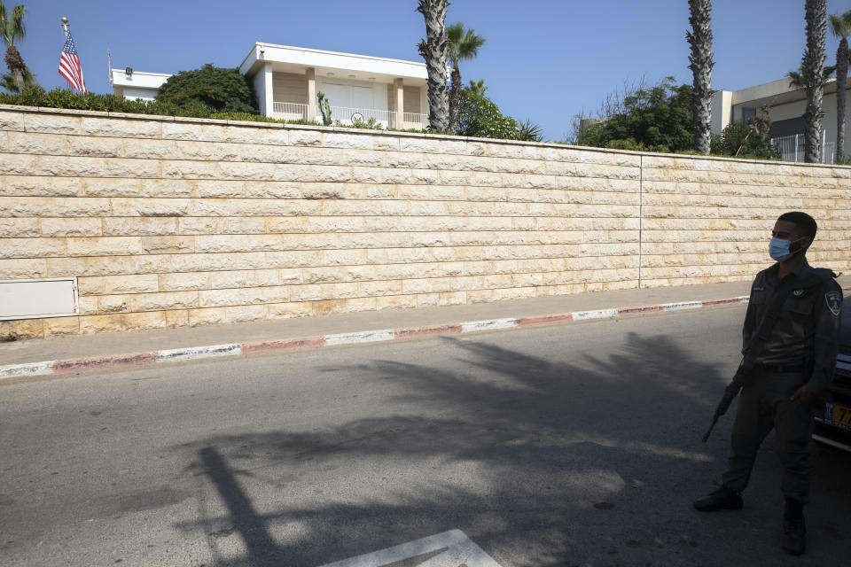 FILE - In this Sept. 9, 2020 file photo, an Israeli border police officer stands guard next to the U.S. ambassador's official residence in the central Israeli city of Herzliya, An official record shows that the United States sold the ambassador’s residence in Israel for more than $67 million in July. The State Department confirmed the sale in September but refused to identify the buyer or disclose the sale price of the sprawling beachfront compound in the upscale Tel Aviv suburb of Herzliya. (AP Photo/Sebastian Scheiner, File)