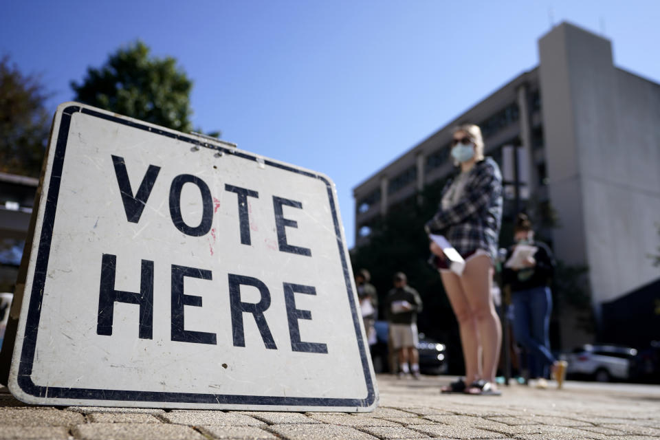 FILE - Voters stand in a line as they wait to vote early on Oct. 19, 2020, in Athens, Ga. Lawyers on Monday, July 18, 2022, asked a federal judge to block Georgia's 2021 ban on giving gifts including food and water to voters waiting in line. (AP Photo/John Bazemore, File)