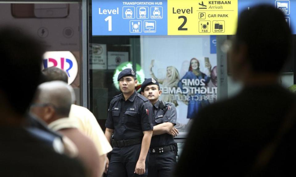 Police officers patrol inside the Kuala Lumpur airport after the assassination of Kim Jong-nam.