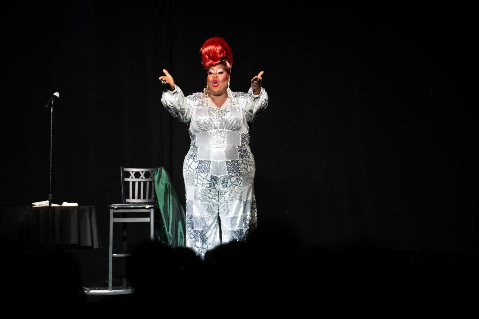 Latrice Royale makes an on-stage costume change during a lip sync of a Christmas song Wednesday, Dec. 13, 2023, at Wooly's in Des Moines.