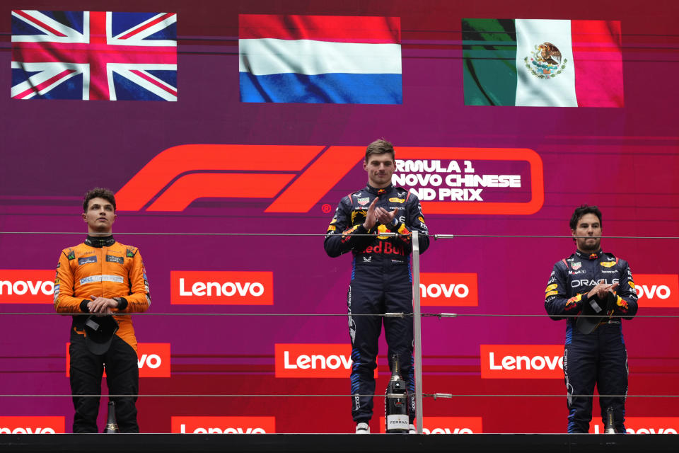 Winner Red Bull driver Max Verstappen of the Netherlands, center, celebrates on the podium with second placed McLaren driver Lando Norris of Britain, left, and third Red Bull driver Sergio Perez of Mexico after the Chinese Formula One Grand Prix at the Shanghai International Circuit, Shanghai, China, Sunday, April 21, 2024. (AP Photo)
