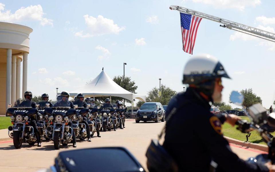 Members of Arlington Police Department’s Motorcycle Unit, left, line up for the funeral procession of fellow officer Darrin McMichael on Wednesday, September 27, 2023, at Crossroads Christian Church in Grand Prairie. The unit left a space open in the lineup that McMichael previously would have occupied.