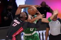 Miami Heat forward Bam Adebayo (13) struggles to maintain control of the ball against Boston Celtics' Jayson Tatum, rear, during the second half of Game 4 of an NBA basketball Eastern Conference final, Wednesday, Sept. 23, 2020, in Lake Buena Vista, Fla. (AP Photo/Mark J. Terrill)