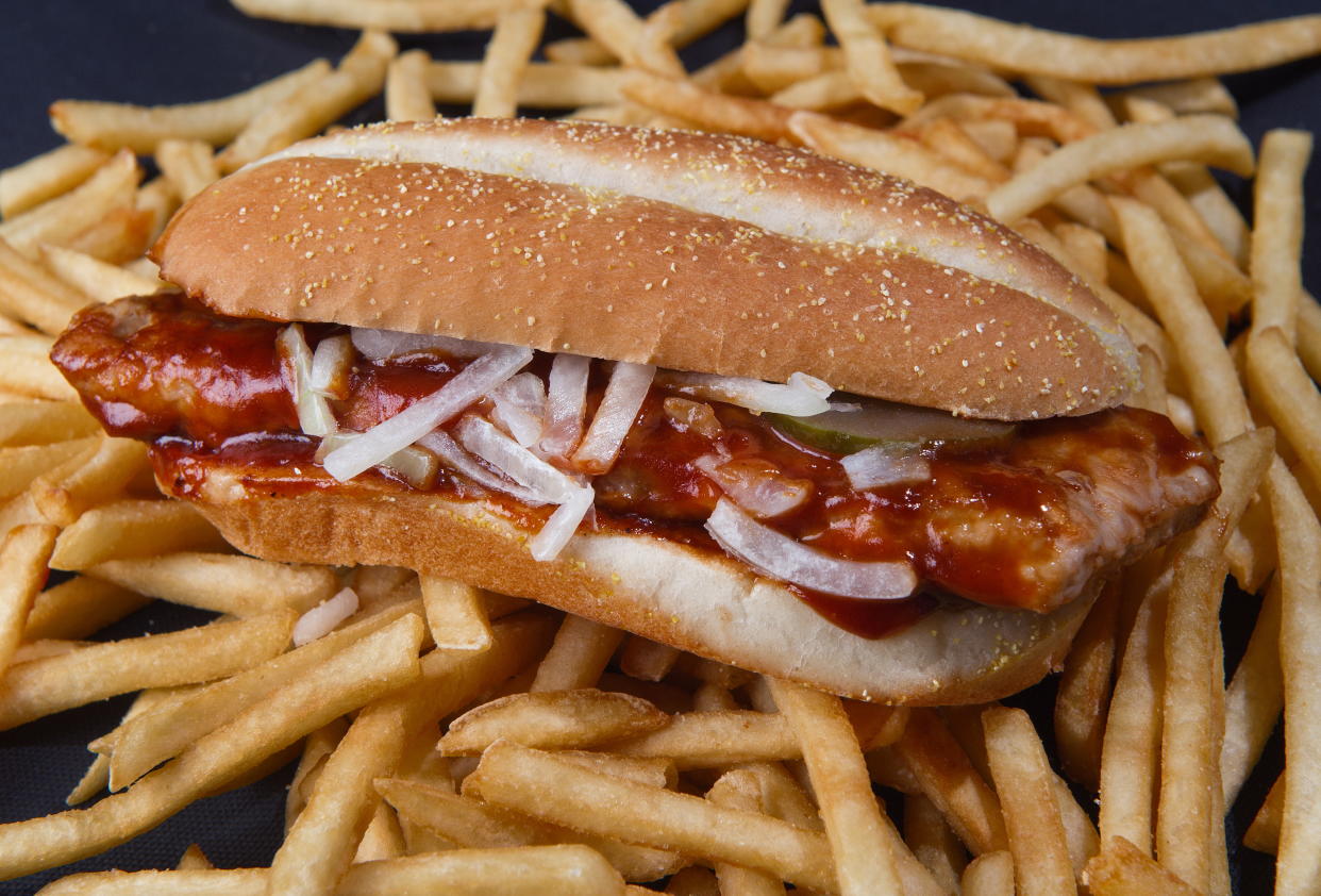 Behold the McRib: a boneless pork chop between a bun and slathered with tangy BBQ sauce, topped with onions and pickles, was first launched in 1981, and with rare exceptions has only been offered for sale in select McDonald's for a few weeks at a time. (Photo: PAUL J. RICHARDS/AFP/Getty Images)