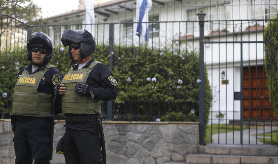 Police stand outside the residence of Uruguay's ambassador to Peru, in Lima, Peru, Sunday, Nov. 18, 2018. Former Peruvian President Alan Garcia has sought asylum in Uruguay's diplomatic mission hours after a judge retained his passport as part of a corruption probe, Peru's foreign ministry announced Sunday. (AP Photo/Karel Navarro)