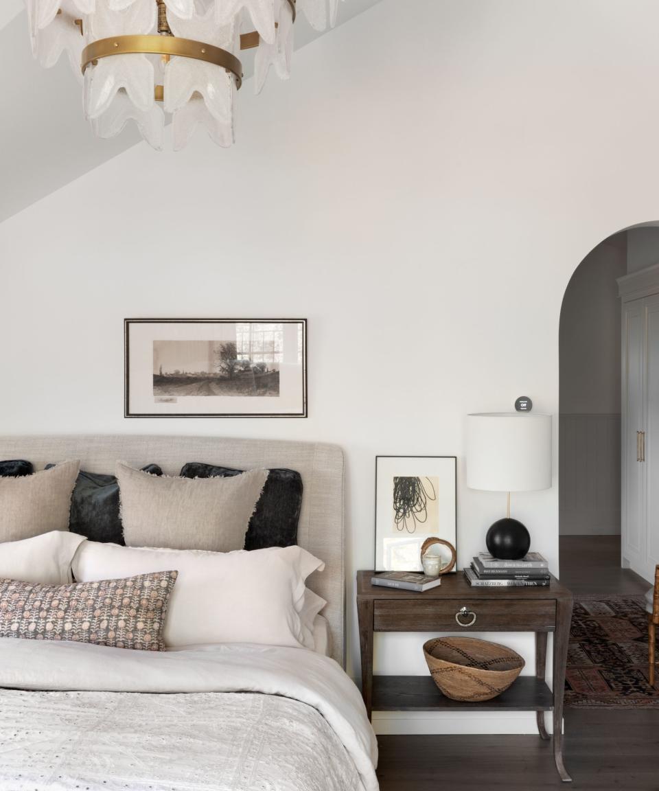 bedroom with arched doorway and neutral colors