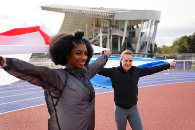 Kadeena Cox and Laura Muir hold flags aloft behind them 