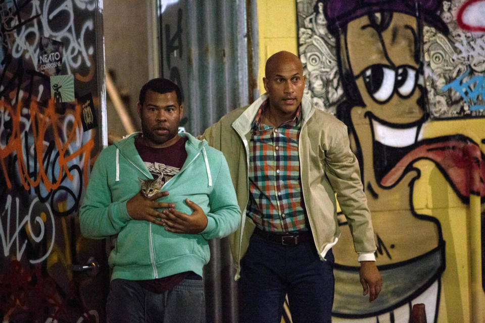 (L, R) Jordan Peele as Rell Dresden (holding a cat in his hoodie) and Keegan-Michael Key as Clarence Dresden in Keanu