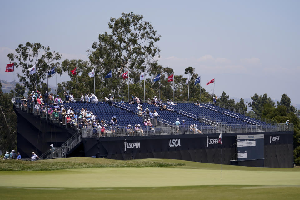 Fans sit in the stands on the 18th hole during the third round of the U.S. Open golf tournament at Los Angeles Country Club on Saturday, June 17, 2023, in Los Angeles. (AP Photo/George Walker IV)