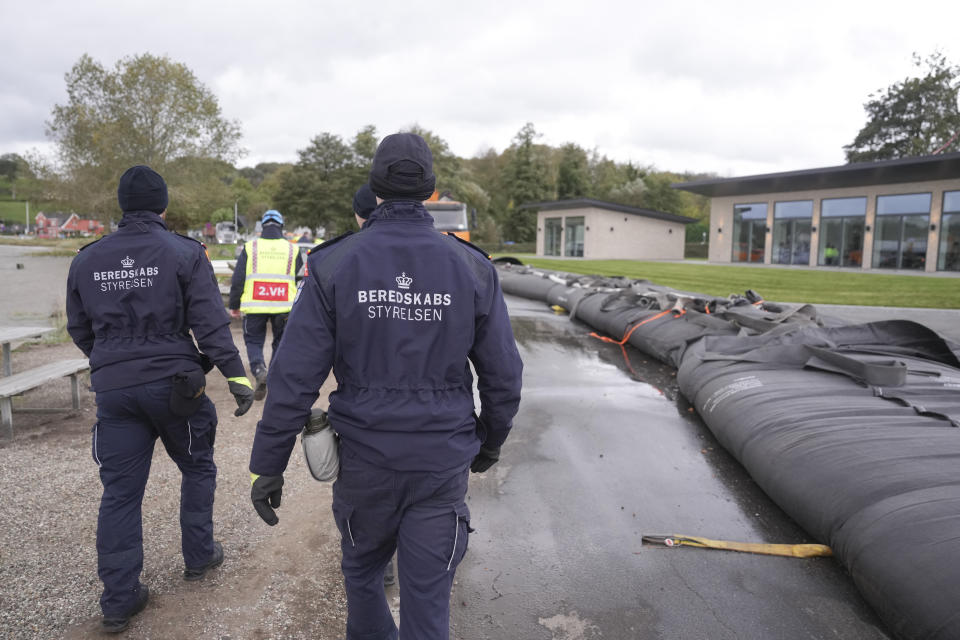 Employees from The Danish Emergency Management Agency prepare for the storm to come at Sonderballe Strand near Haderslev southern, Denmark Thursday, Oct. 19, 2023. Southern Scandinavia and northern Germany braced for bad weather with gale force winds over the next days. Authorities said Thursday that floods could cause major problems in inner Danish waters and in the Baltic Sea. (Claus Fisker/Ritzau Scanpix via AP)