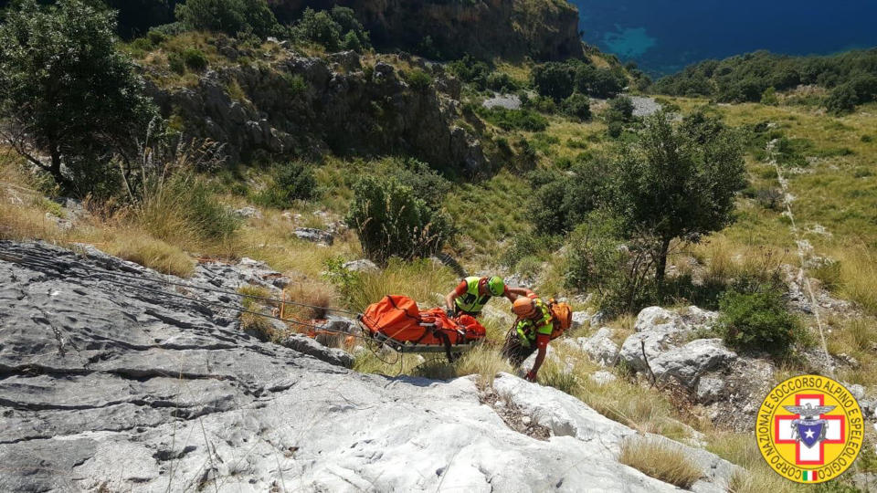 Members of the Italian mountain rescue team search for a French hiker in the Cilento region, Southern Italy, Monday, Aug. 19, 2019. Italian mountain rescue squads have recovered the body of a French hiker who fell into a ravine and broke his leg. Nine days of search ended Sunday when alpine rescue spotted Simon Gautier’s backpack and then his body in a ravine in the Cilento region of Southern Italy. Crews were able to recover the body Monday. (Corpo Nazionale Soccorso Alpino e Speleologico via AP)