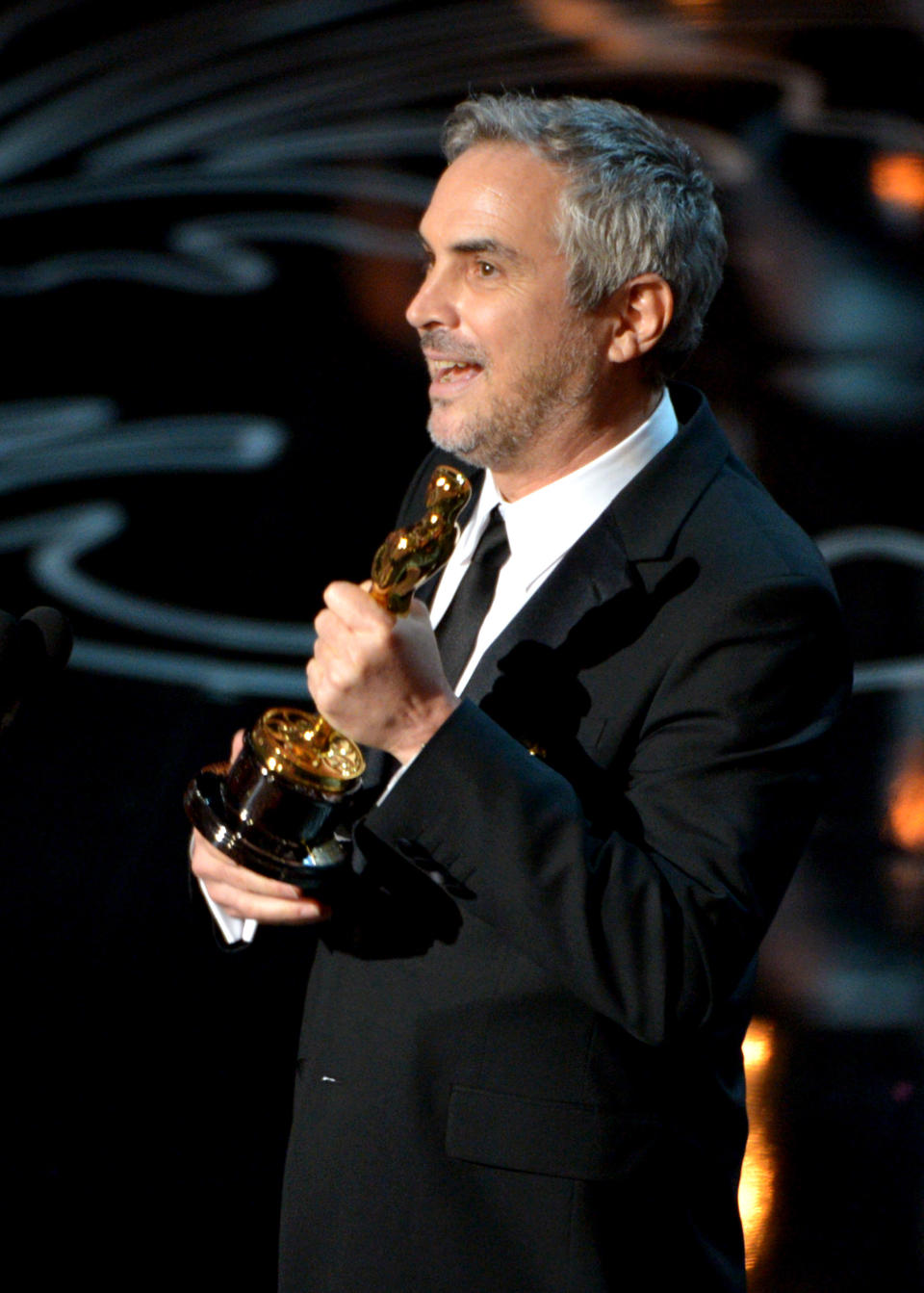 Alfonso Cuaron accepts the award for best director for "Gravity" during the Oscars at the Dolby Theatre on Sunday, March 2, 2014, in Los Angeles. (Photo by John Shearer/Invision/AP)