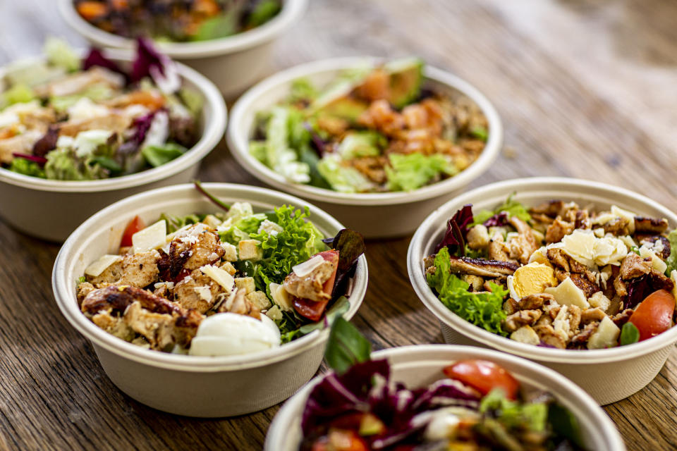 Takeout bowls lined up on a table