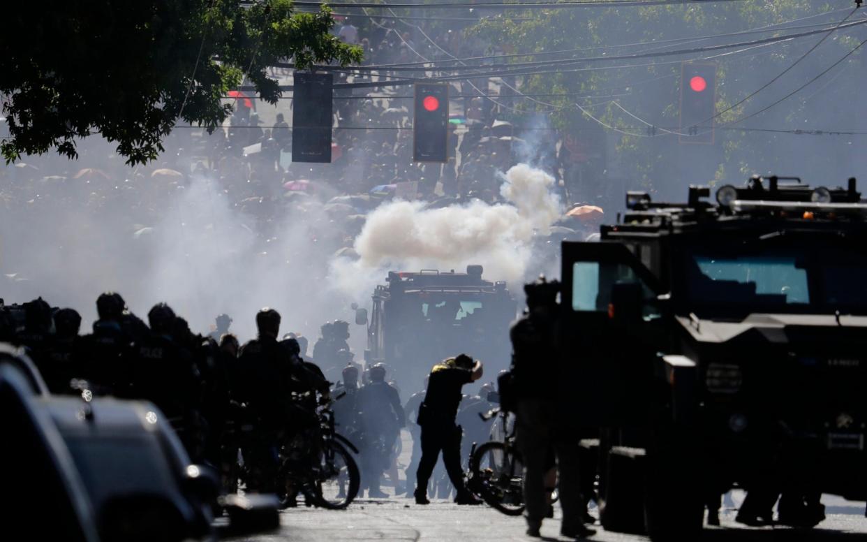 Smoke rises as police clash with protesters - AP