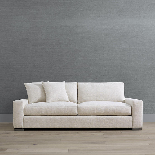 cream colored sleeper sofa against gray wall