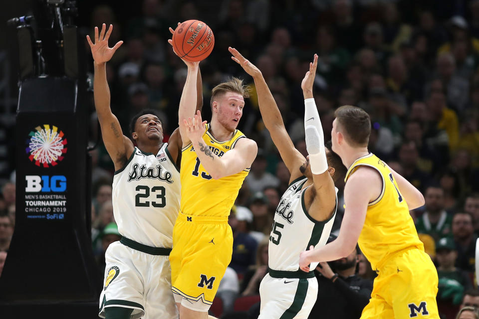 CHICAGO, IL - MARCH 17: Michigan Wolverines forward Ignas Brazdeikis (13) battles with Michigan State Spartans forward Xavier Tillman (23) and Michigan State Spartans forward Kenny Goins (25) during a Big Ten Tournament Championship game between the Michigan Wolverines and the Michigan State Spartans on March 17, 2019, at the United Center in Chicago, IL. (Photo by Robin Alam/Icon Sportswire via Getty Images)