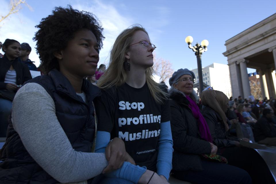 Anyeli Arias (L) and Sara Fossum (R) gather with thousands of people at Civic Center Park in Denver, Colorado for the Protect Our Muslim Neighbors Rally on February 4, 2017.