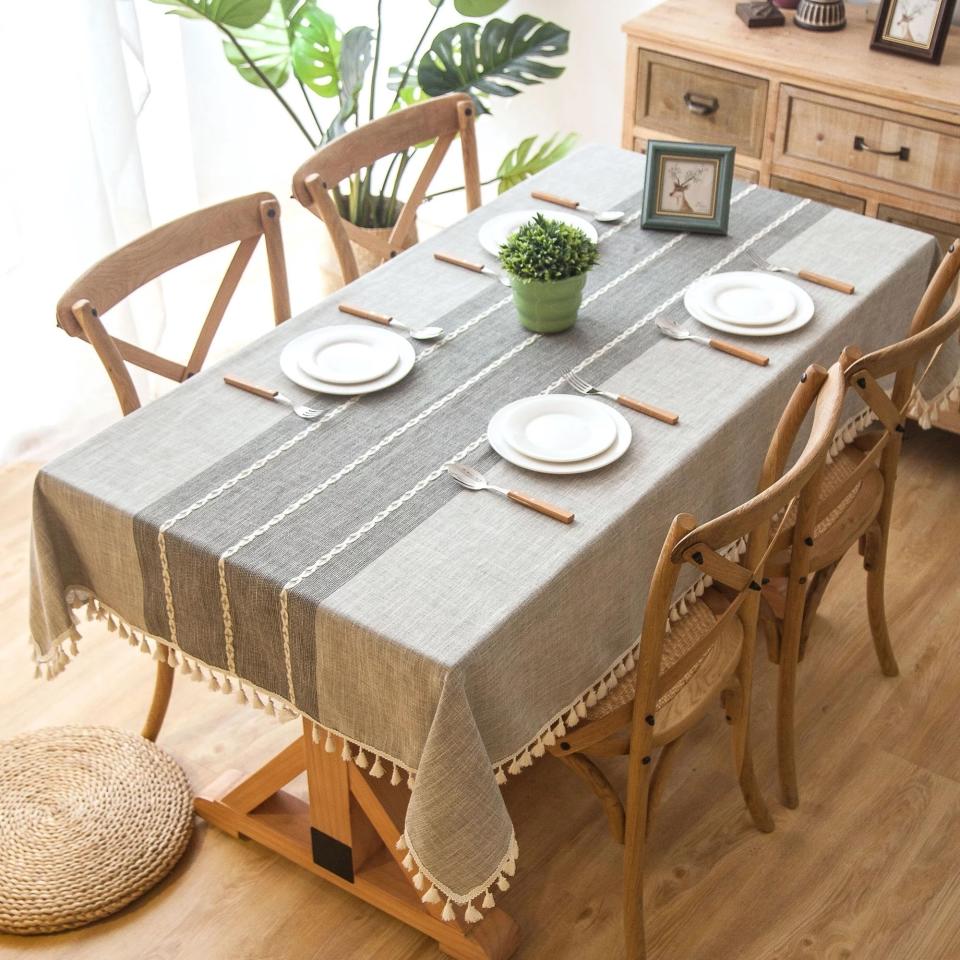 gray linen table cloth with tassels on a table