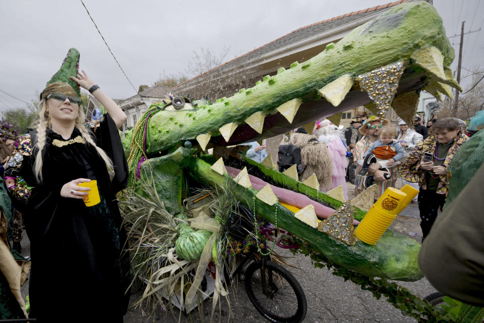 People walk in costumes during the Society of Saint Anne parade through Bywater and Marigny neighborhoods on Mardi Gras Day in New Orleans, Tuesday, Feb. 13, 2024. (AP Photo/Matthew Hinton)