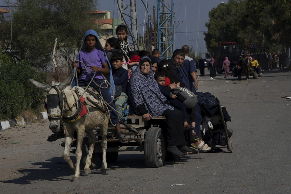 Palestinians flee to the southern Gaza Strip along Salah al-Din Street, on the outskirts of Gaza City, during the ongoing Israeli bombardment on Saturday, Nov. 18, 2023. (AP Photo/Adel Hana)