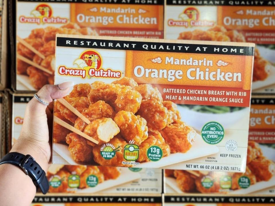 The writer holds Crazy Cuizine Mandarin-orange chicken