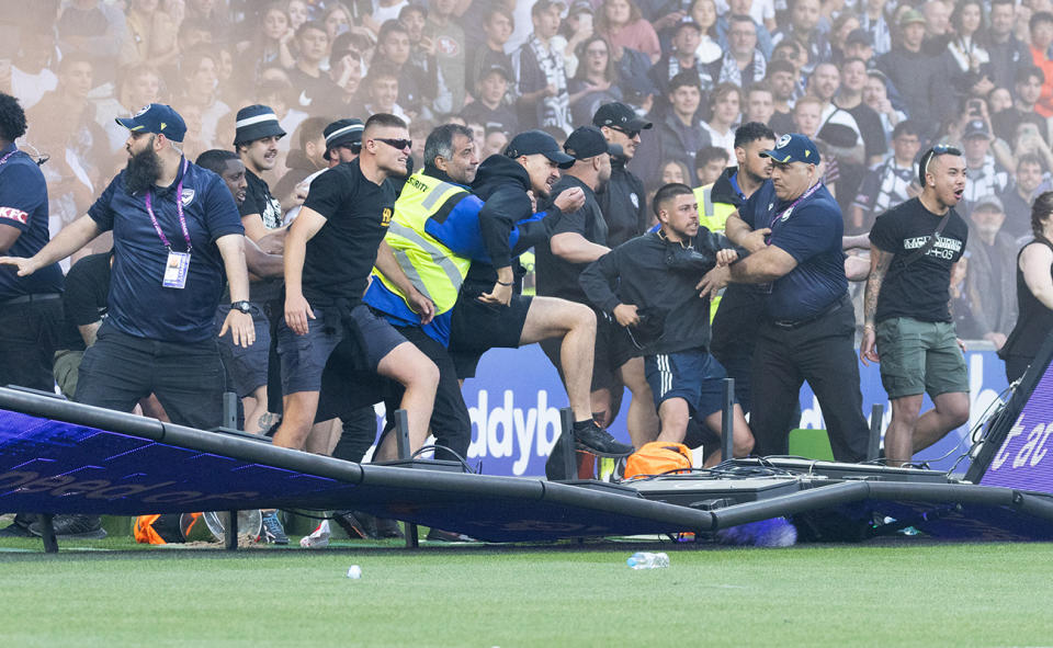 Fans, pictured here invading the pitch during Melbourne Victory's clash with Melbourne City in the A-League. 