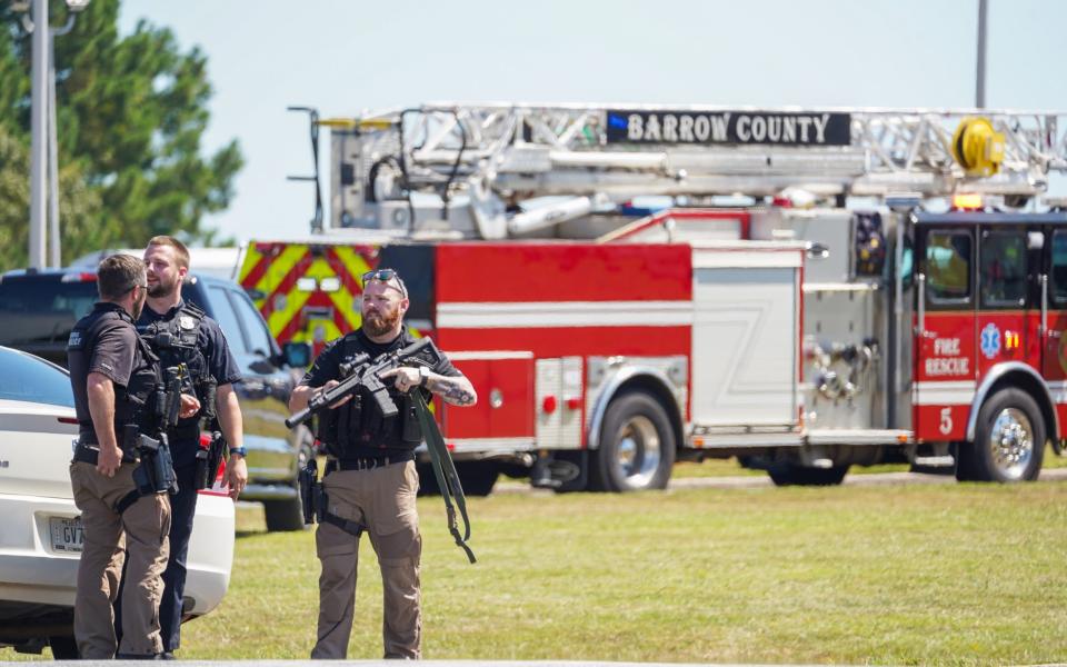 Armed police stand guard at the school