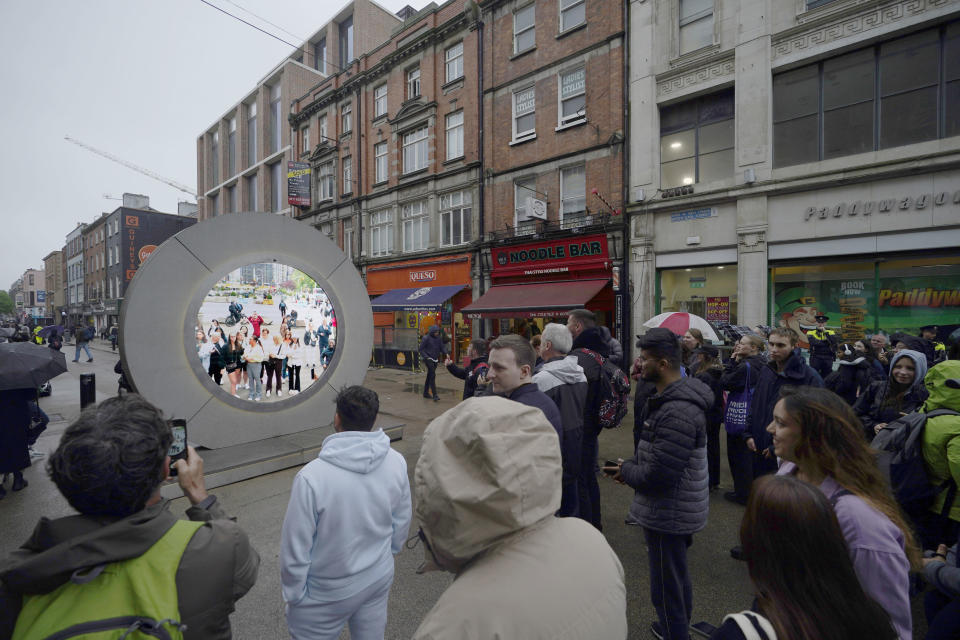 People view the live stream portal between Dublin and New York, in Dublin, Ireland, on Monday May 13, 2024. (Niall Carson/PA via AP)