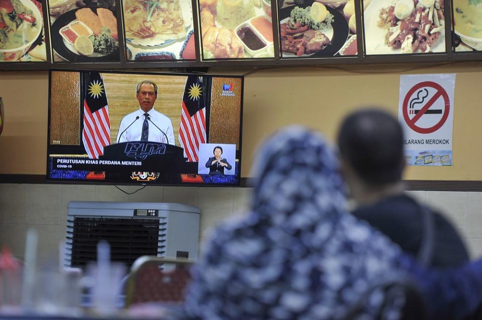 Muhyiddin said this means that all business premises have to be shut down, except for outlets such as supermarkets and grocery stores selling daily essentials.— Picture by Shafwan Zaidon