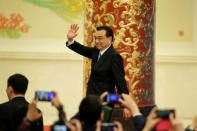 Chinese Premier Li Keqiang waves as he leaves the news conference following the closing session of the National People's Congress (NPC), at the Great Hall of the People in Beijing, China March 20, 2018. REUTERS/Jason Lee