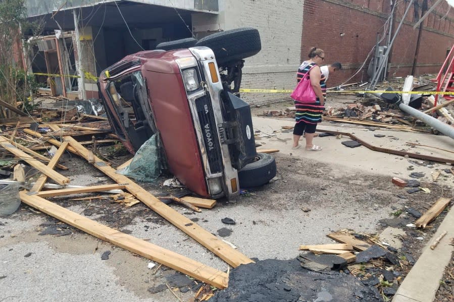 A car lies on its side after being knocked over during a tornado that tore through downtown Sulphur, Okla., Sunday, April 28, 2024. (AP Photo/Ken Miller)